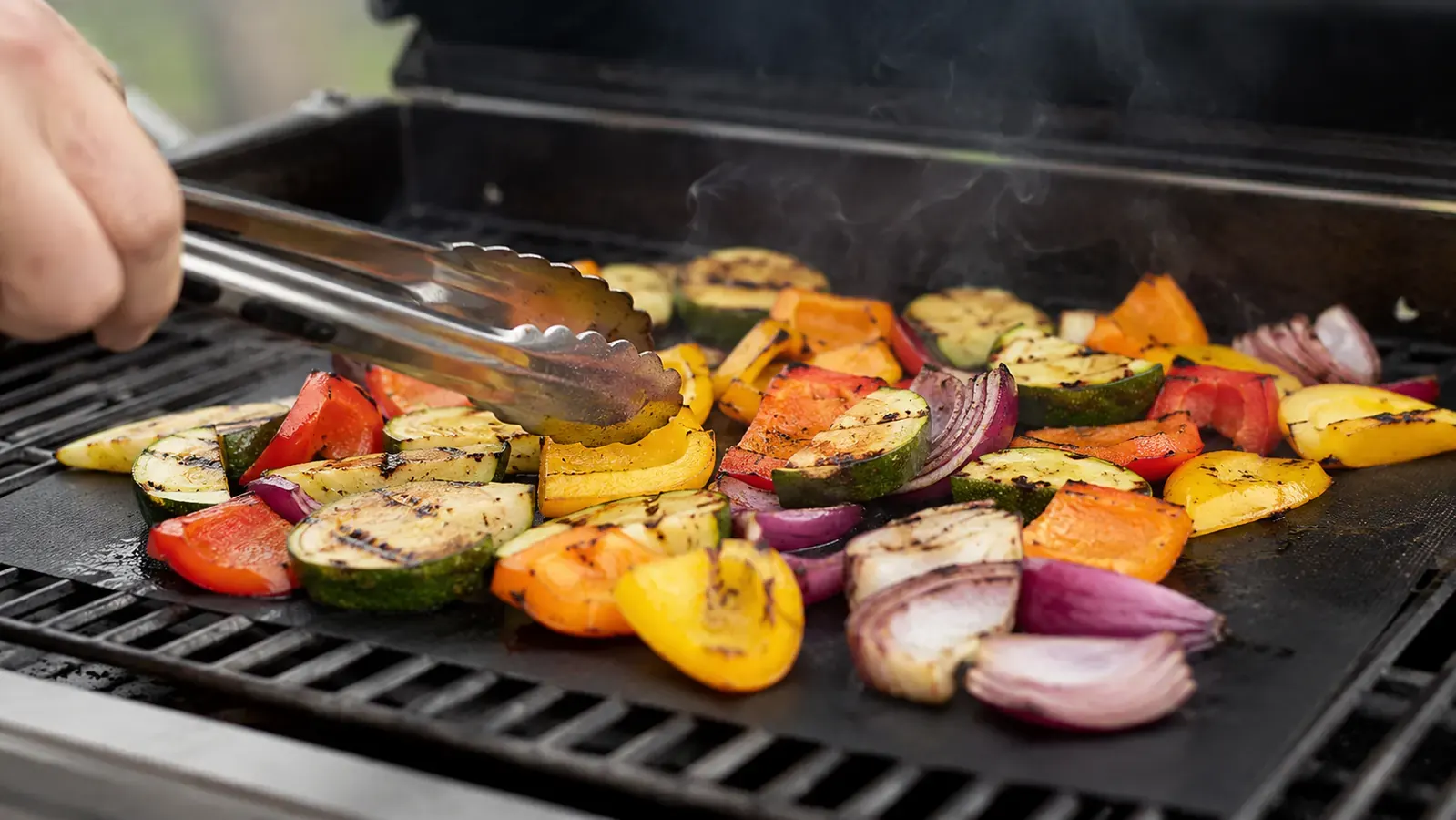 Grilled asparagus and mushrooms with visible sear marks after being cooked on a grill mat