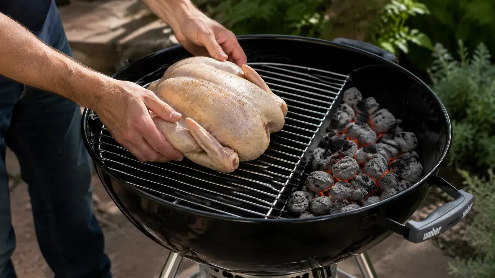 Chicken thighs and corn on the cob arranged on the grill grate of a Weber kettle, grill marks forming